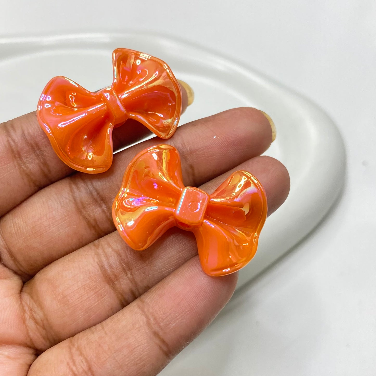 AC 1144 Orange bow iridescent Acrylic bead - per piece