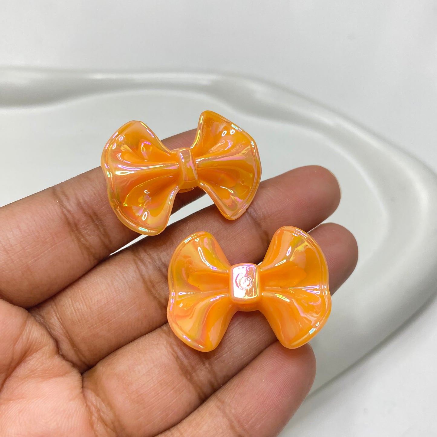 AC 1146 light orange bow iridescent Acrylic bead - per piece