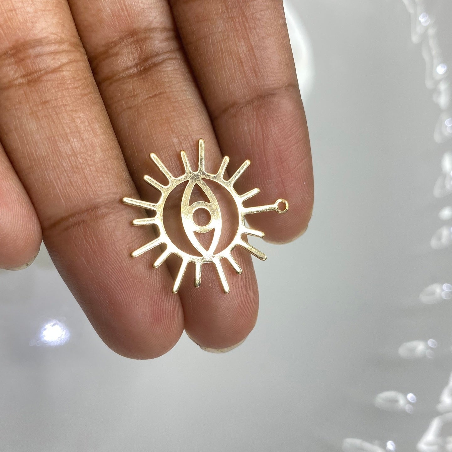 B52 polished evil eye sun charm