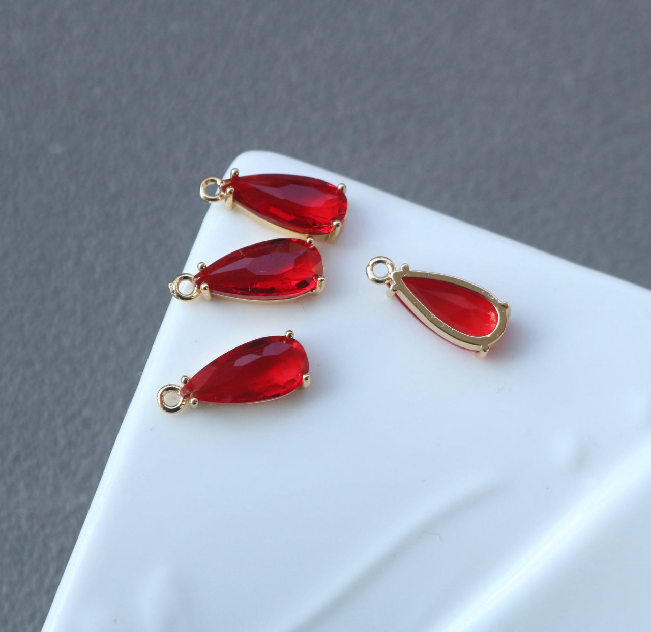 CZ 1114 - Red crystal gold plated teardrop charm - per piece